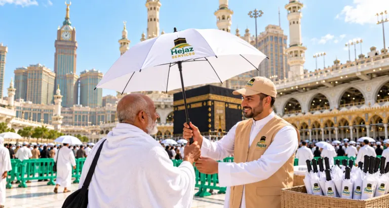 Hejaz Services volunteer giving a branded umbrella to a pilgrim at Masjid al-Haram