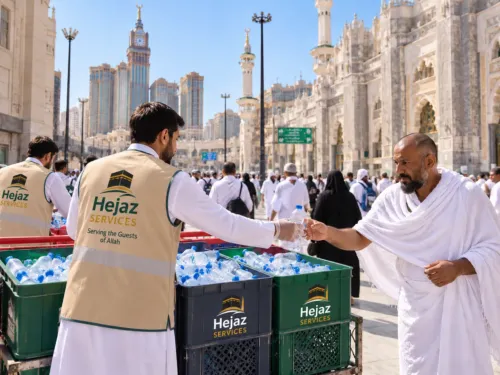 Hejaz Services volunteers giving bottled water to pilgrims in Makkah